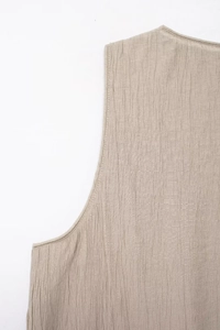 Close-up of beige textured fabric with professional single-needle stitching detail