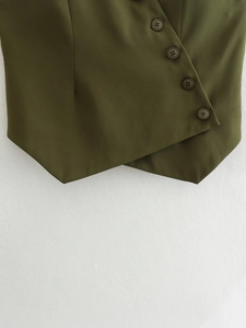 Detail of olive green asymmetric vest hem with overlapping design and four round buttons