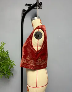 Detail of sequins embroidery and floral patterns on deep red velvet vest for women