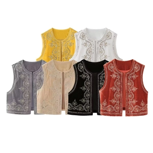 Detailed view of sequin embroidered velvet vests in various bohemian floral patterns