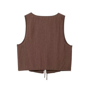 Detailed close-up of dark brown sleeveless top with textured pleated fabric and tie detail