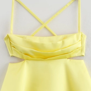 Bright yellow satin dress featuring cross straps, pleated bust, and side cut-outs