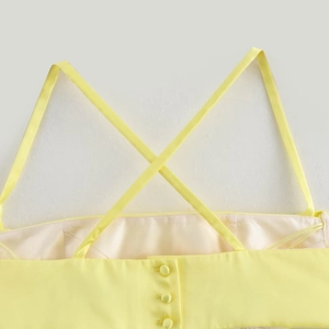 Chic lemon yellow strapless dress with cross-back straps and elegant back buttons