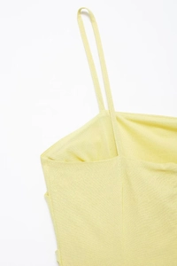 Close-up of the fine spaghetti straps and neckline on this light yellow summer dress