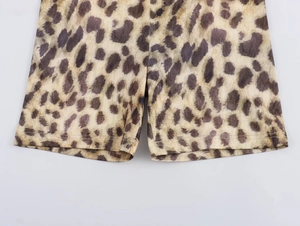 Detailed close-up of leopard print cycling shorts showing high-quality double-needle stitching