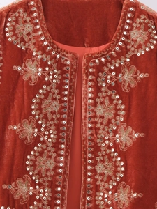 Detail of velvet vest with gold embroidery and silver sequins in ethnic patterns