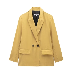 Detail of a ginger yellow double-breasted blazer with notched lapel and dark buttons
