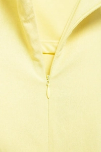 Detailed macro view of high-quality invisible zipper on a pale yellow summer dress