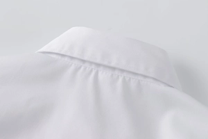 Close-up of the classic lapel collar and neat stitching on this white long sleeve shirt