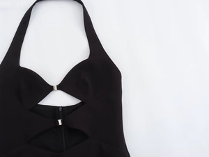 Detailed view of black halter neck dress with silver buckle and cutout design