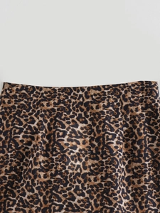 Close-up detail of premium leopard print fabric and neat stitching on summer skirt