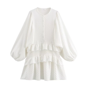 White tiered ruffle dress with puff sleeves and textured checkered fabric design