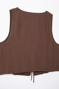 Macro detail of dark brown textured sleeveless vest with back lace-up drawstring design