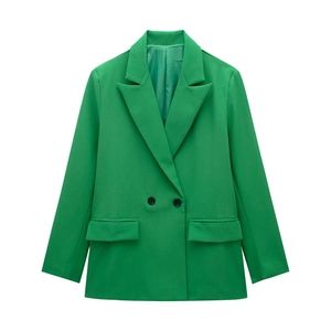 Detail of green double-breasted blazer with peak lapels and flap pockets on plain white background