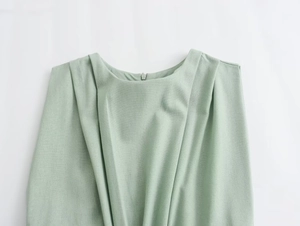 Detailed view of sage green dress neck with shoulder pleats and hidden zipper