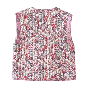 Detail view of quilted floral vest with ethnic prints and pink contrast binding