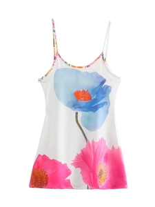 Detail of artistic floral print on a white summer strap dress featuring pink and blue flowers