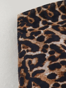 Detailed close-up showing the leopard print pattern and weave texture of the cotton fabric