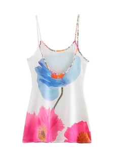 Detail of white floral print slip dress showing delicate straps and digital flower pattern