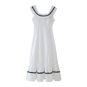Women's sleeveless white cotton dress with black ric-rac trim and ruffles for summer wear