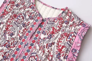 Detail of ethnic floral print and diamond quilting on a sleeveless cotton vest jacket