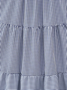 Detailed close-up of blue and white gingham fabric with tiered ruffle stitching details