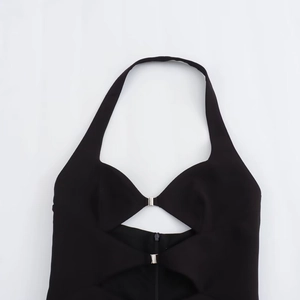 Women's black halter neck dress with modern cut-out design and silver buckle detail