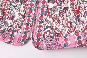 Detail of bohemian floral paisley print and striped quilting on the cotton vest