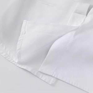 Minimalist white long sleeve shirt with premium stitching details and textured fabric