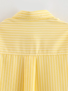 Detail of yellow and white striped blouse showing horizontal and vertical stripe contrast
