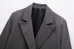 Macro detail of the grey blazer notched lapel with mixed twill fabric and black lining