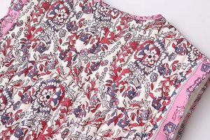 Close-up of quilted ethnic floral pattern with bohemian paisley details and pink piping