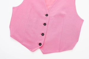Detailed view of pink V-neck vest buttons and textured blend fabric of the set