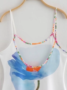 Detail of floral print on white summer dress with colorful piping and thin straps