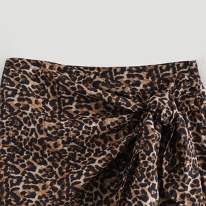 Women's leopard print wrap skirt with adjustable waist tie and bold animal pattern