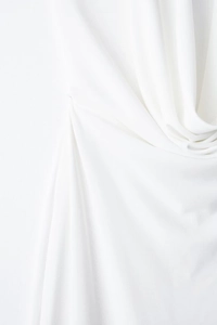 Close-up of white textile fabric texture with soft vertical pleats and subtle sheen