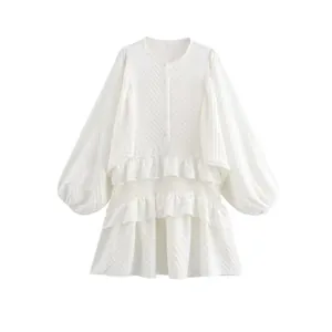 Elegant white puff sleeve dress with tiered ruffle layers and textured fabric finish