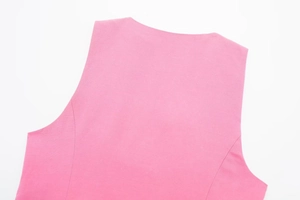 Macro detail of pink linen vest showing high-quality fabric texture and smooth stitching