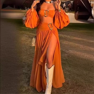 Orange two-piece resort set with bubble sleeve crop top and high-slit maxi skirt