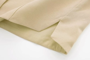 Detailed close-up of side slit design and linen texture on beige summer shorts set