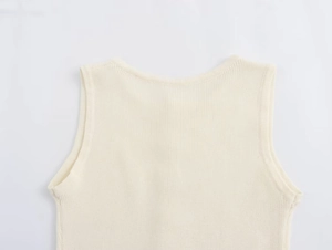 Detailed view of the round neckline and reinforced armhole on this cream knit dress