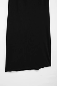 Detailed macro view of black fine ribbed knit fabric texture of the halter dress