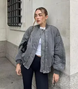 Detailed view of grey quilted bomber jacket with oversized fit and wave pattern texture