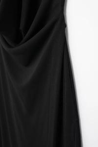 Close-up of pleated halter neckline on a black summer dress with soft draped fabric