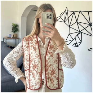 Women's vintage quilted vest with red floral Toile de Jouy pattern and contrast trim