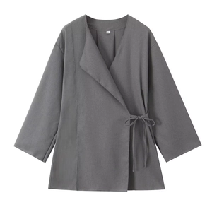 Detailed view of linen blend V-neck wrap top with side bow tie and size S label