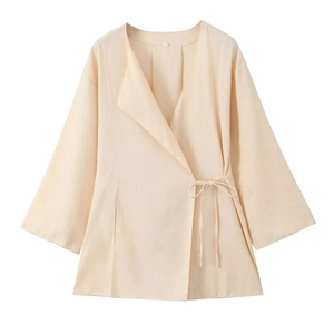 Detail view of the wrap-style linen blend V-neck blazer showing fabric texture and side tie