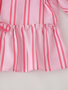 Detail of pink and white striped shirt with waist drawstring and ruffle hem textures