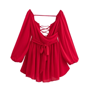Detail of red V-neck dress featuring lace-up open back and elegant waist tie bow