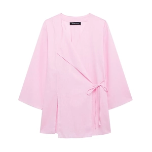 Detail of pink linen wrap top with V-neckline and side tie closure for women